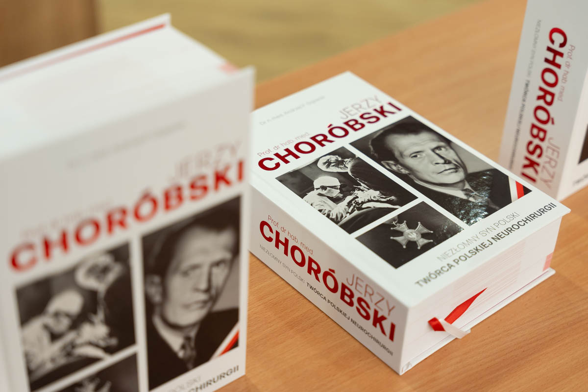 Three copies of the book entitled “Jerzy Choróbski” with white covers, red and black lettering, and black-and-white photographs of Jerzy Choróbski.