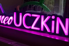 Fioletowy neon z napisem UCZKIN.