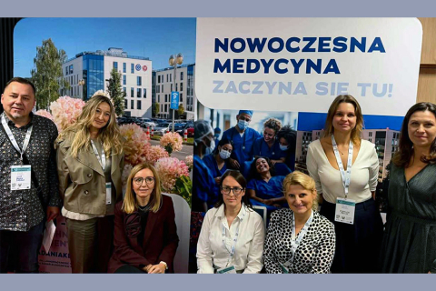 A group of participants from the Medical University of Warsaw posing for a photo in front of a banner reading “Modern Medicine.”